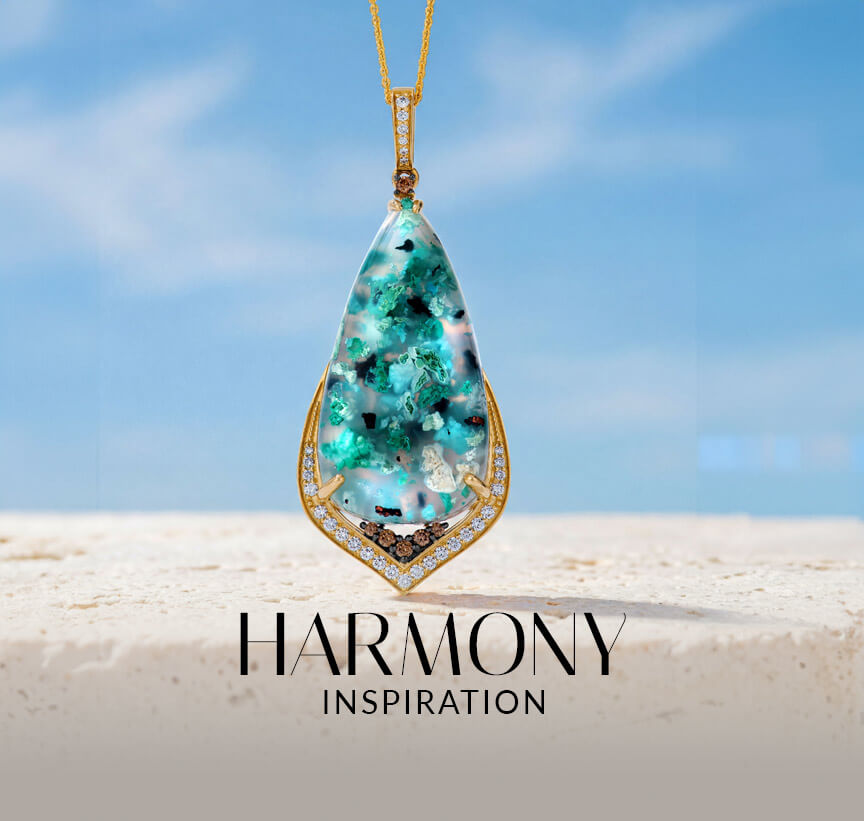 Le Vian® blue-green gemstone pendant with diamond accents against a soft sky background.