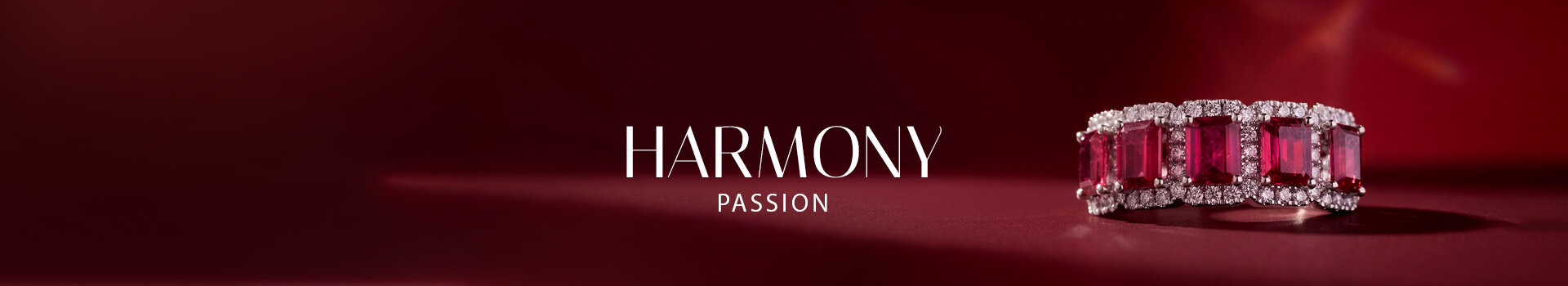 Le Vian® red gemstone ring with diamond accents on a dramatic red background.