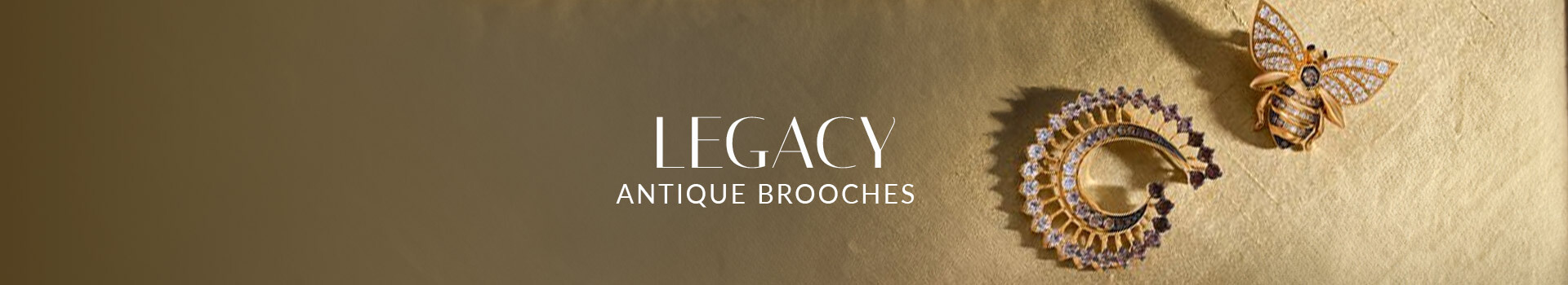 Le Vian® antique-inspired brooches with diamond accents and nature motifs displayed on textured gold fabric.