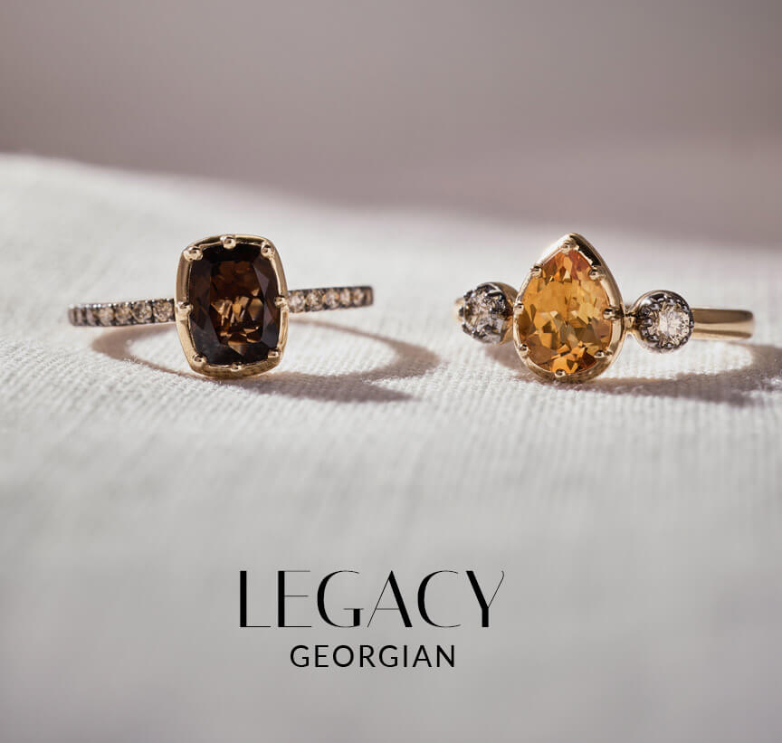 Two Le Vian® Georgian-inspired rings with warm-toned center gemstones and diamond accents on white fabric.