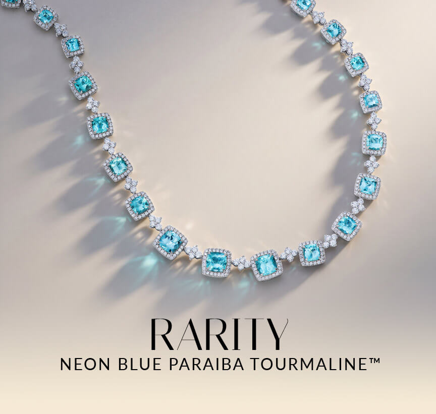 Le Vian® Neon Blue Paraiba Tourmaline™ necklace with diamond accents on a soft neutral background.